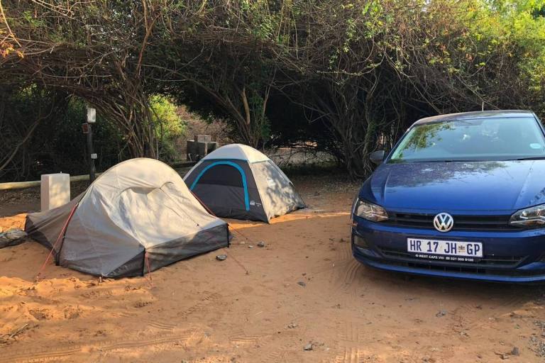 Rental car and tents set up at camp in Kasane